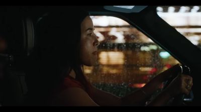 a woman driving a car in the rain