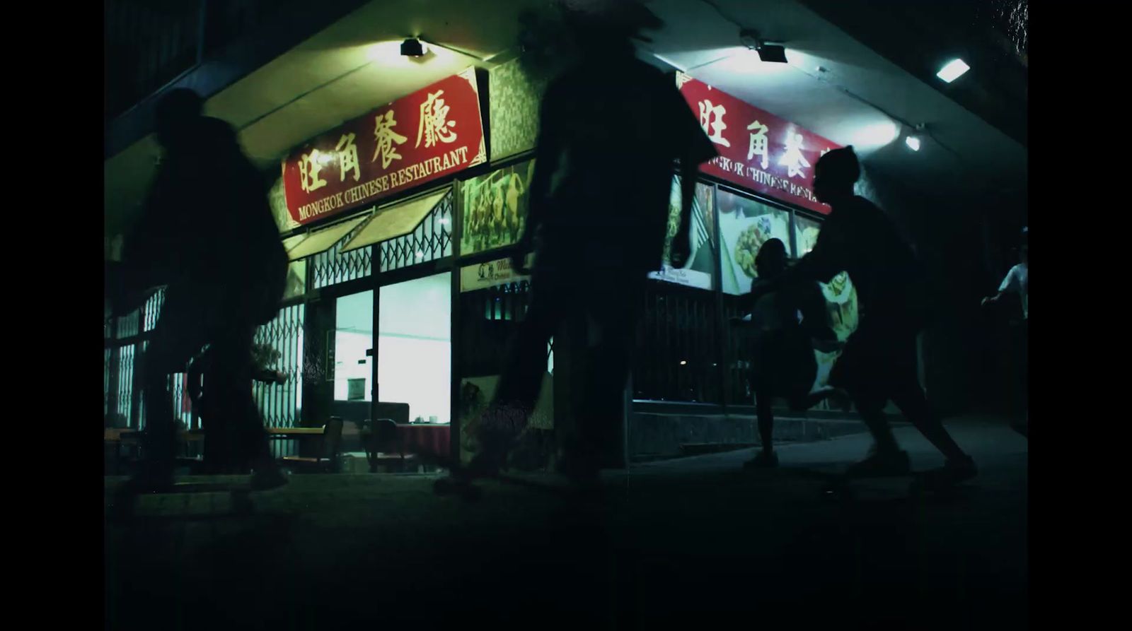 a group of people standing outside of a chinese restaurant