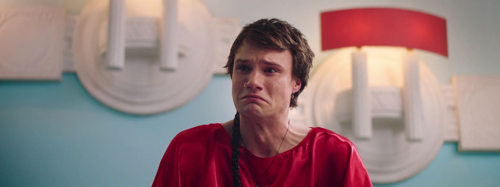 a man in a red shirt looking at the camera