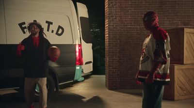 a man standing in front of a van holding a basketball