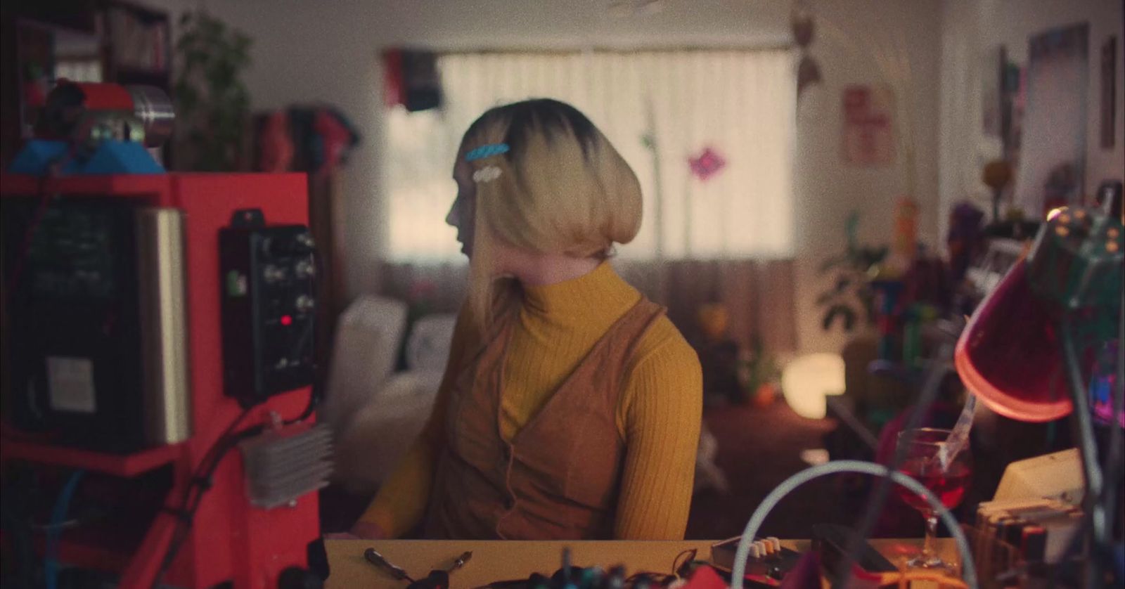 a woman standing in a room filled with clutter