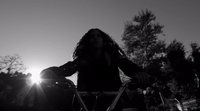 a black and white photo of a woman riding a bike