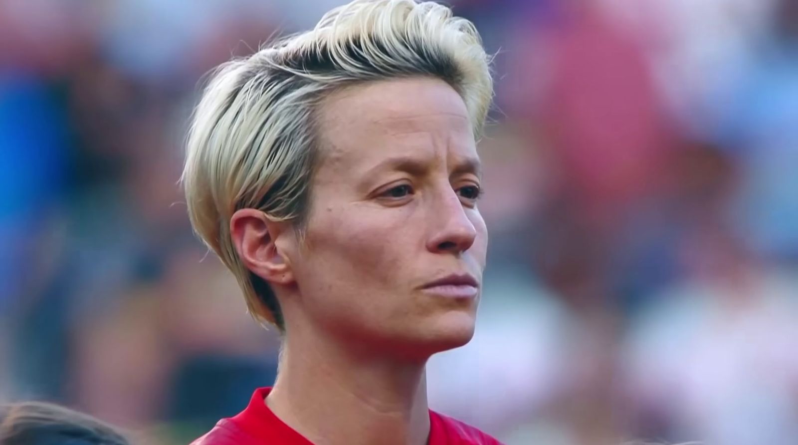 a close up of a person wearing a red shirt