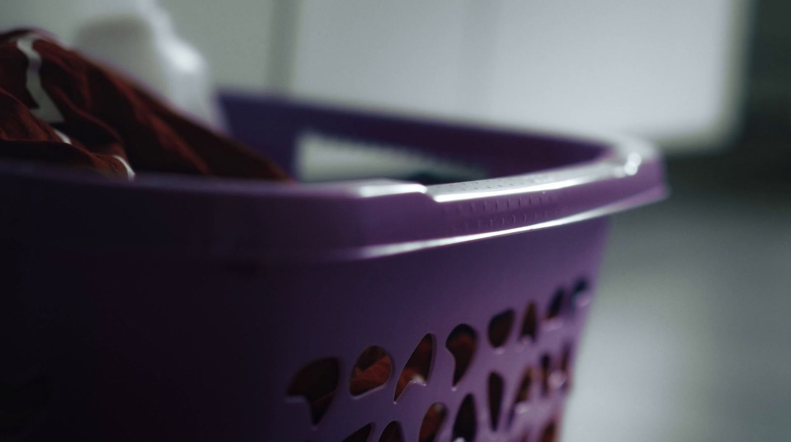 a close up of a purple laundry basket