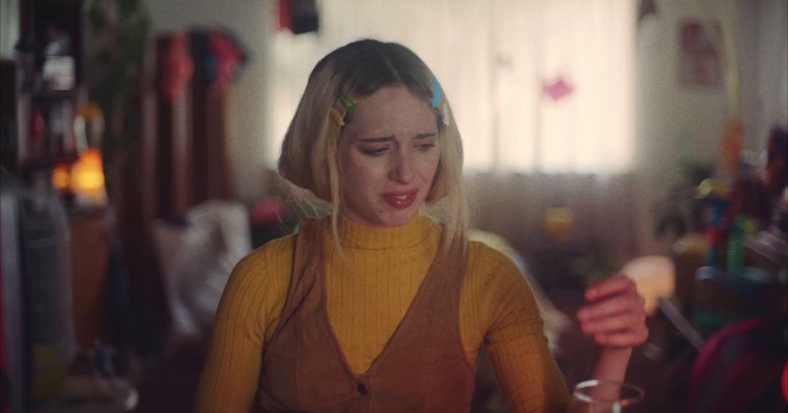 a woman holding a wine glass in a room