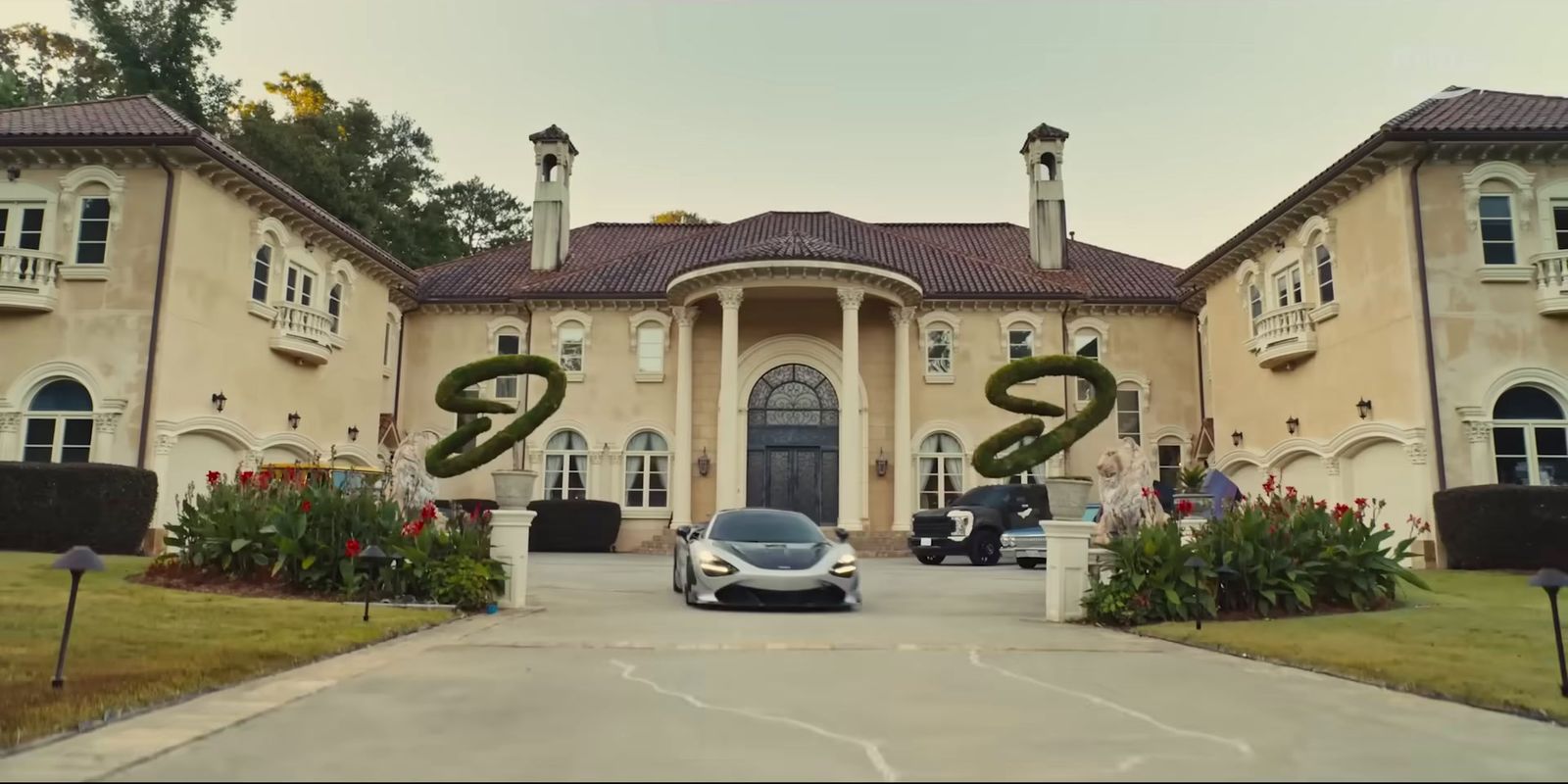 a car parked in front of a large house