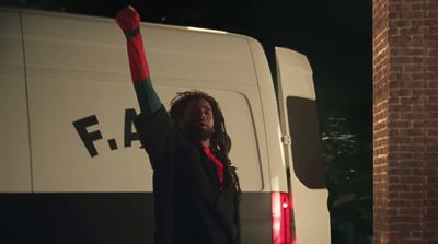 a man standing in front of a white van