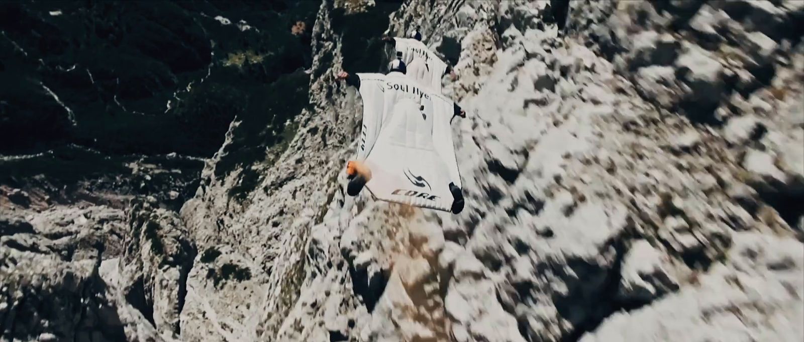 a man climbing up the side of a mountain