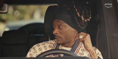 a woman sitting in a car talking on a cell phone