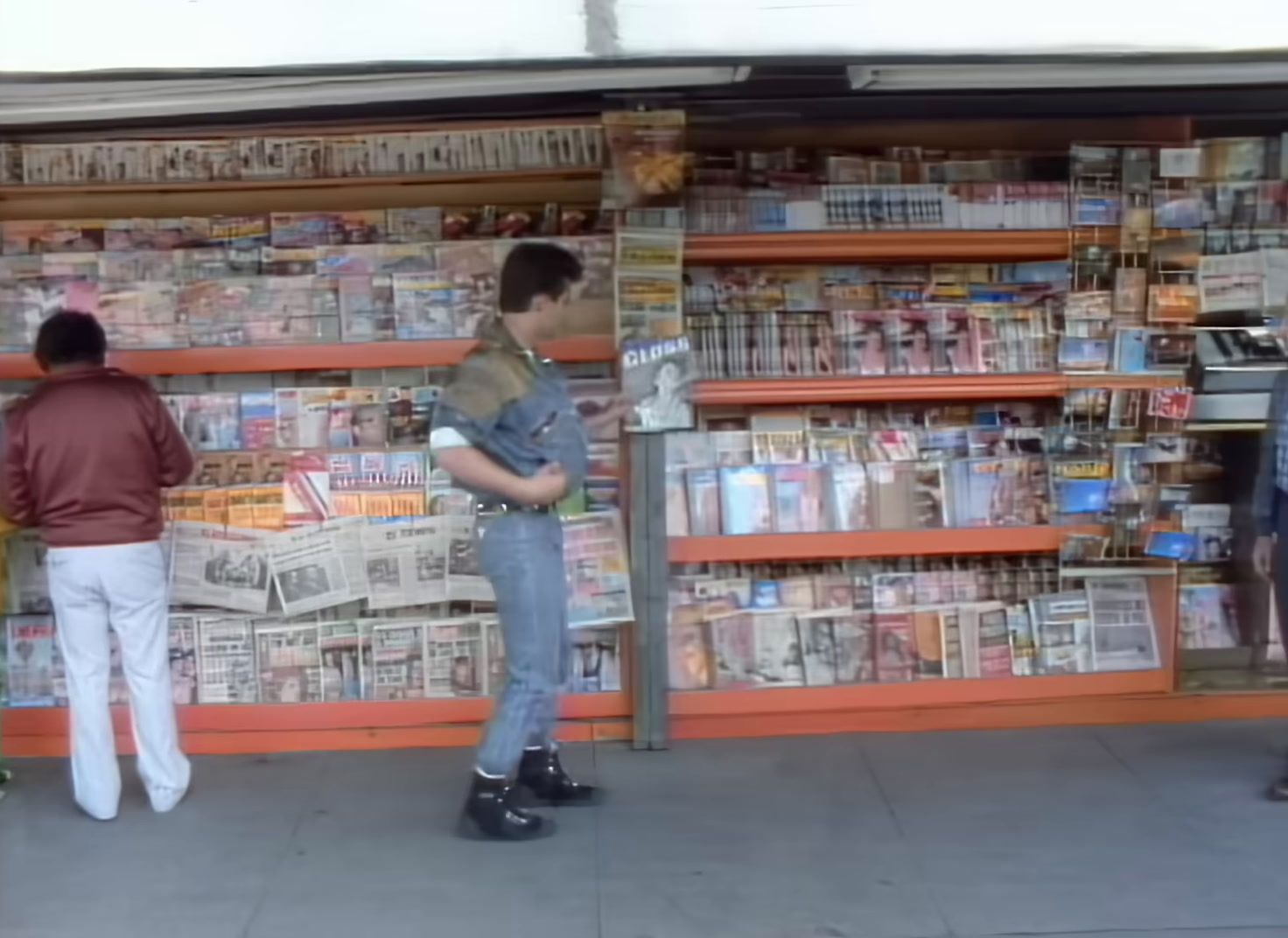 a couple of people standing in front of a store