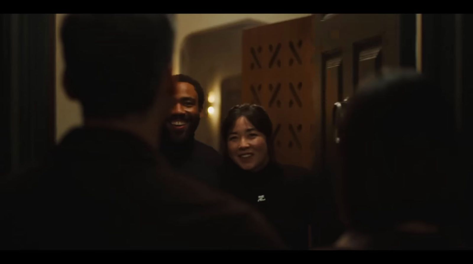 a man and a woman standing in front of a door