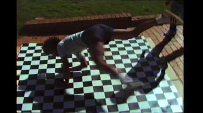 a person standing on a checkered floor with a skateboard