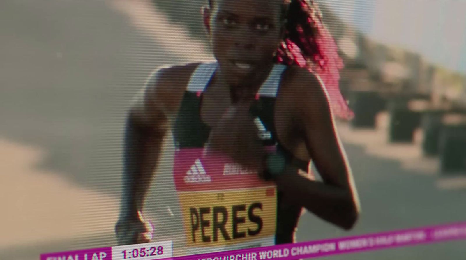 a woman running a race on a television screen