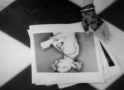 a black and white photo of a woman laying on the floor