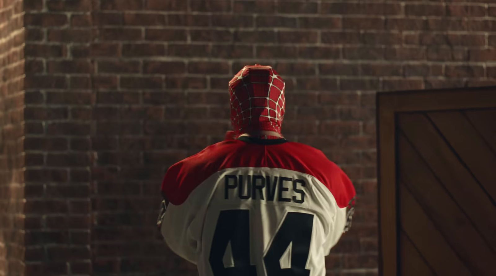 a man wearing a red and white jersey with the number 54 on it