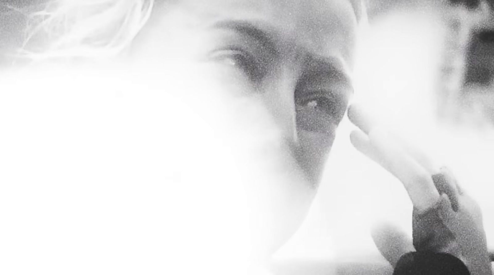 a woman brushing her teeth in front of a mirror