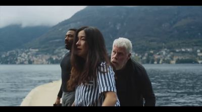 a group of people standing next to a body of water