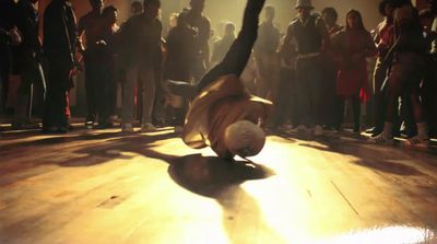 a person doing a handstand on a wooden floor