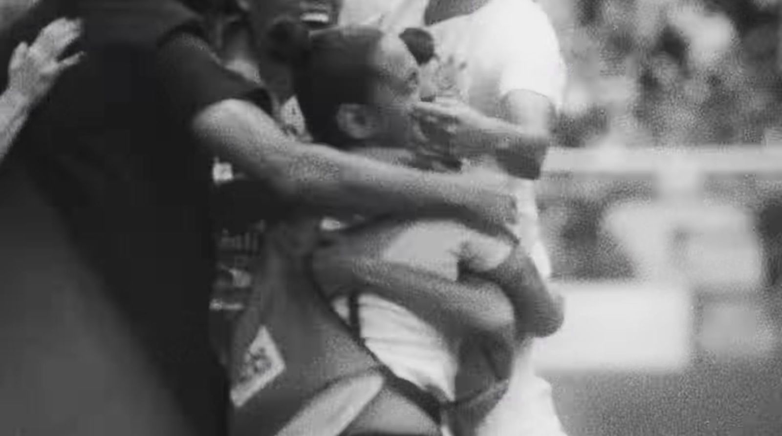 a black and white photo of a man holding a baby