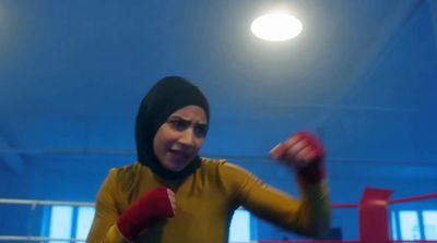 a woman wearing a hijab and boxing gloves