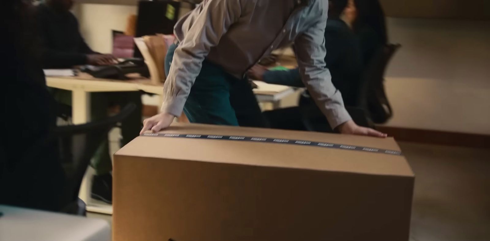 a man standing on top of a cardboard box