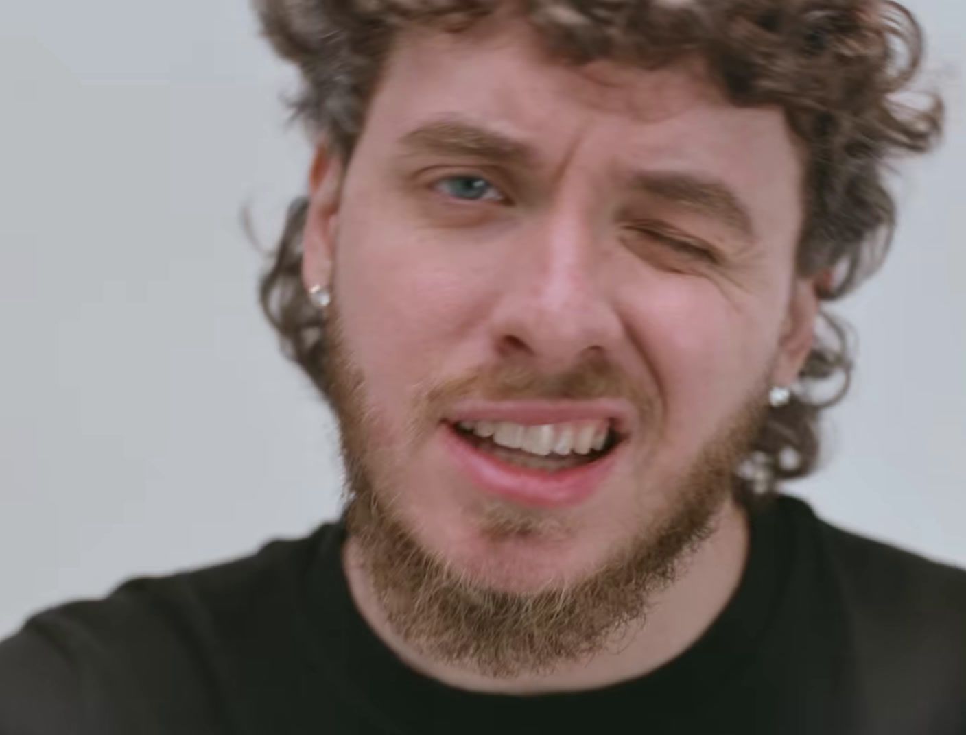 a close up of a person with curly hair