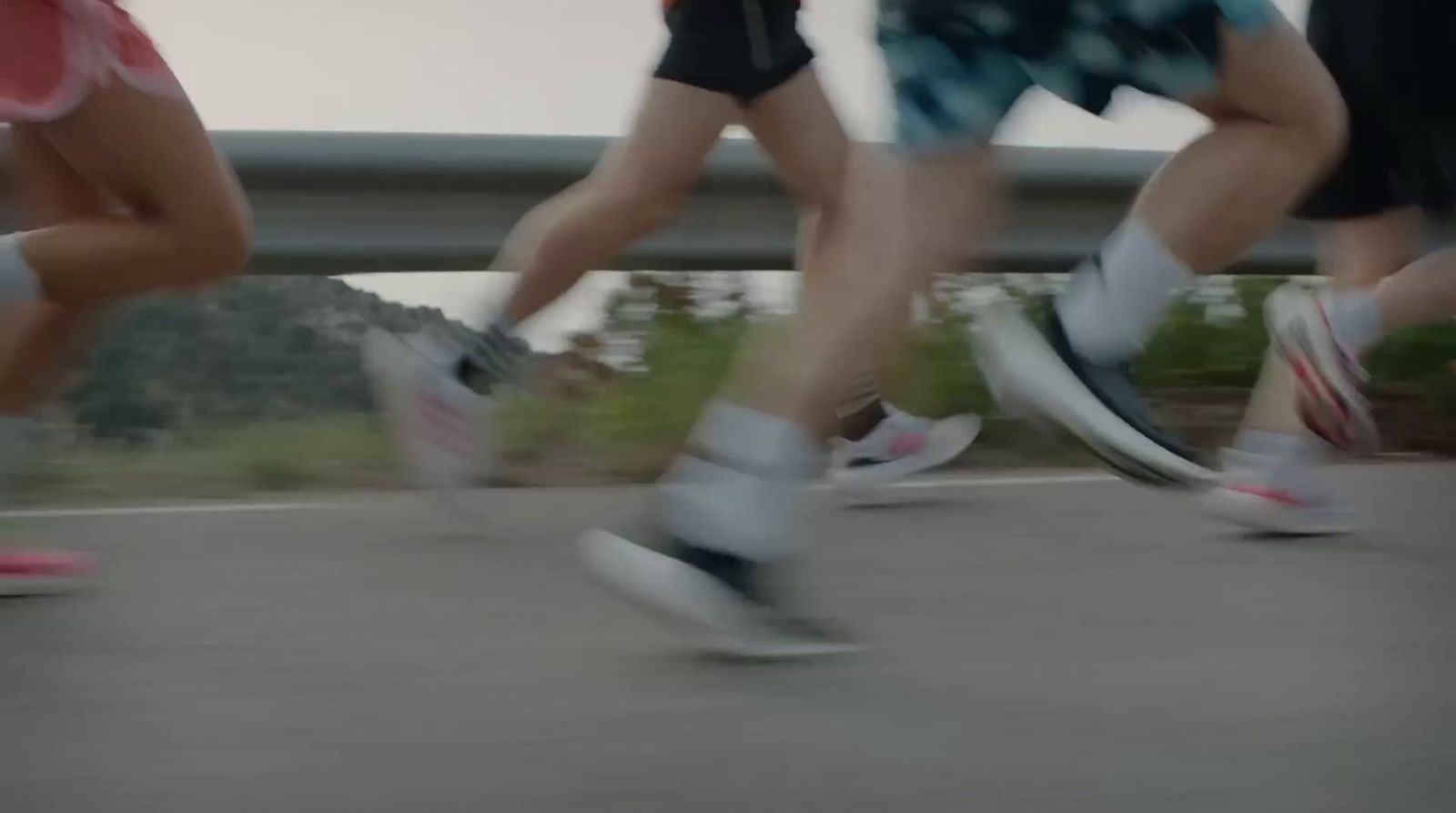 a group of people riding skateboards down a street