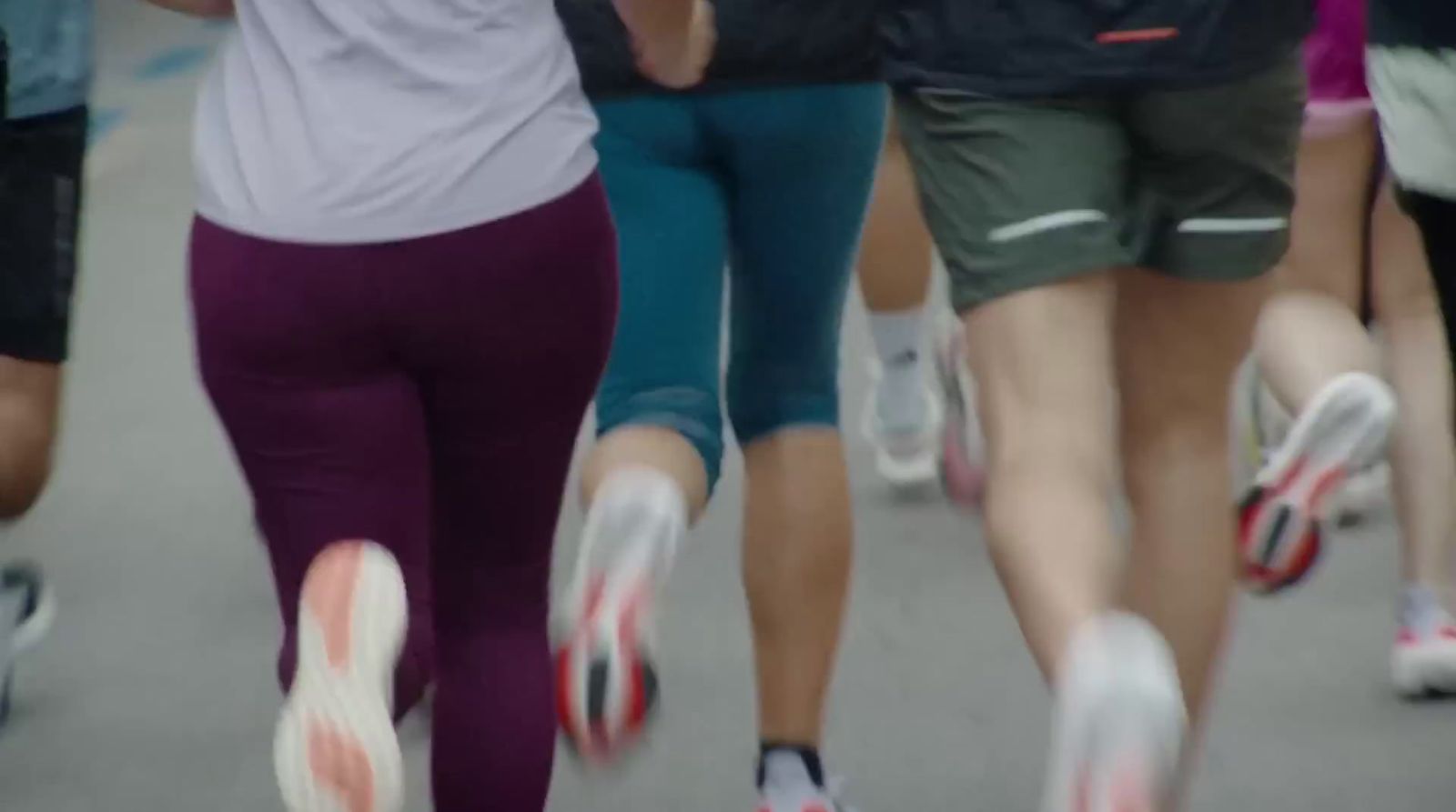 a group of people running down a street