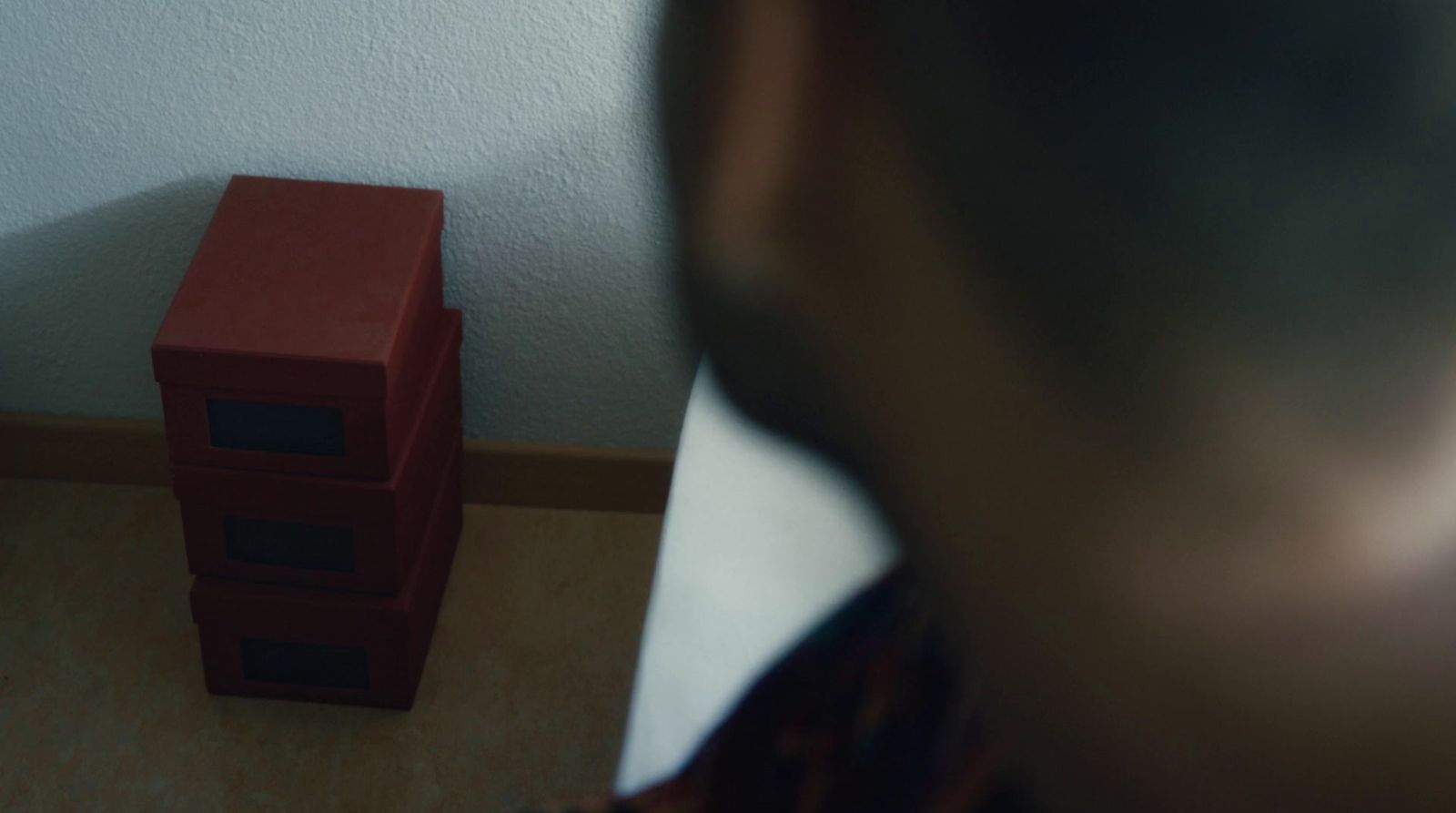 a man standing in front of a red object