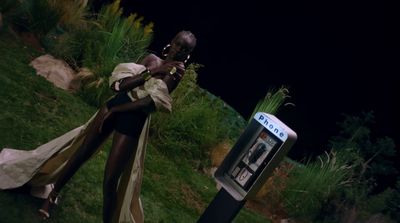 a woman standing next to a parking meter