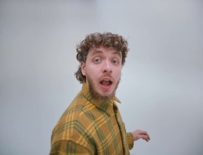 a man with curly hair is making a surprised face