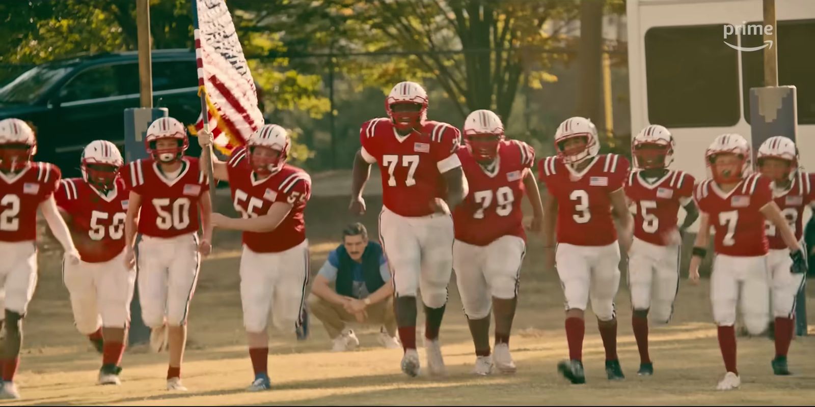 a group of football players walking down a field