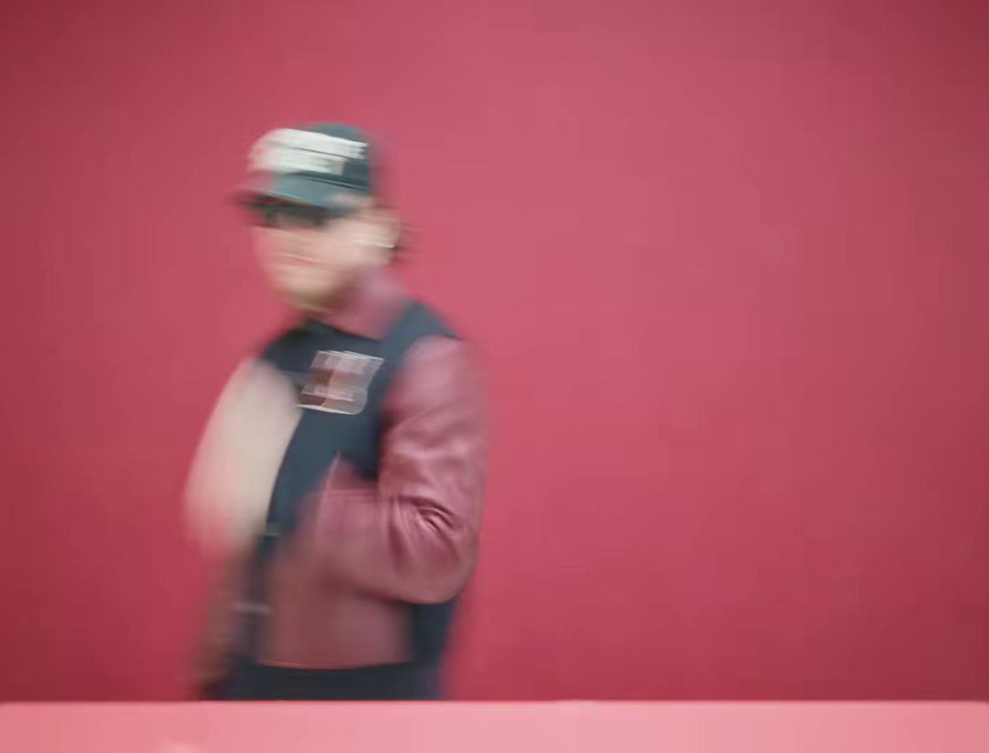 a blurry photo of a man in a baseball cap