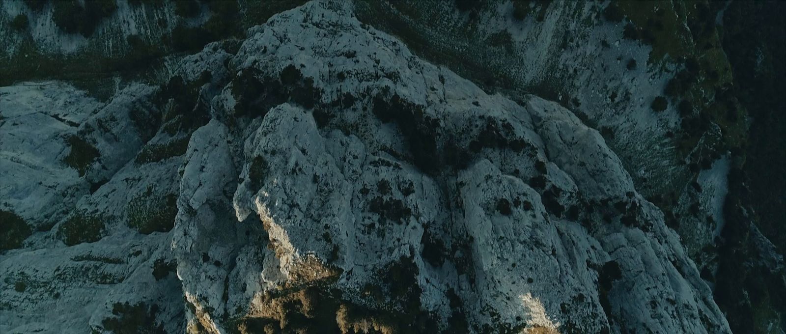 a very tall rock formation with a sky background