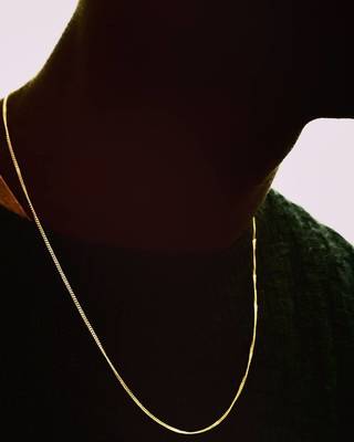 a man wearing a gold chain necklace