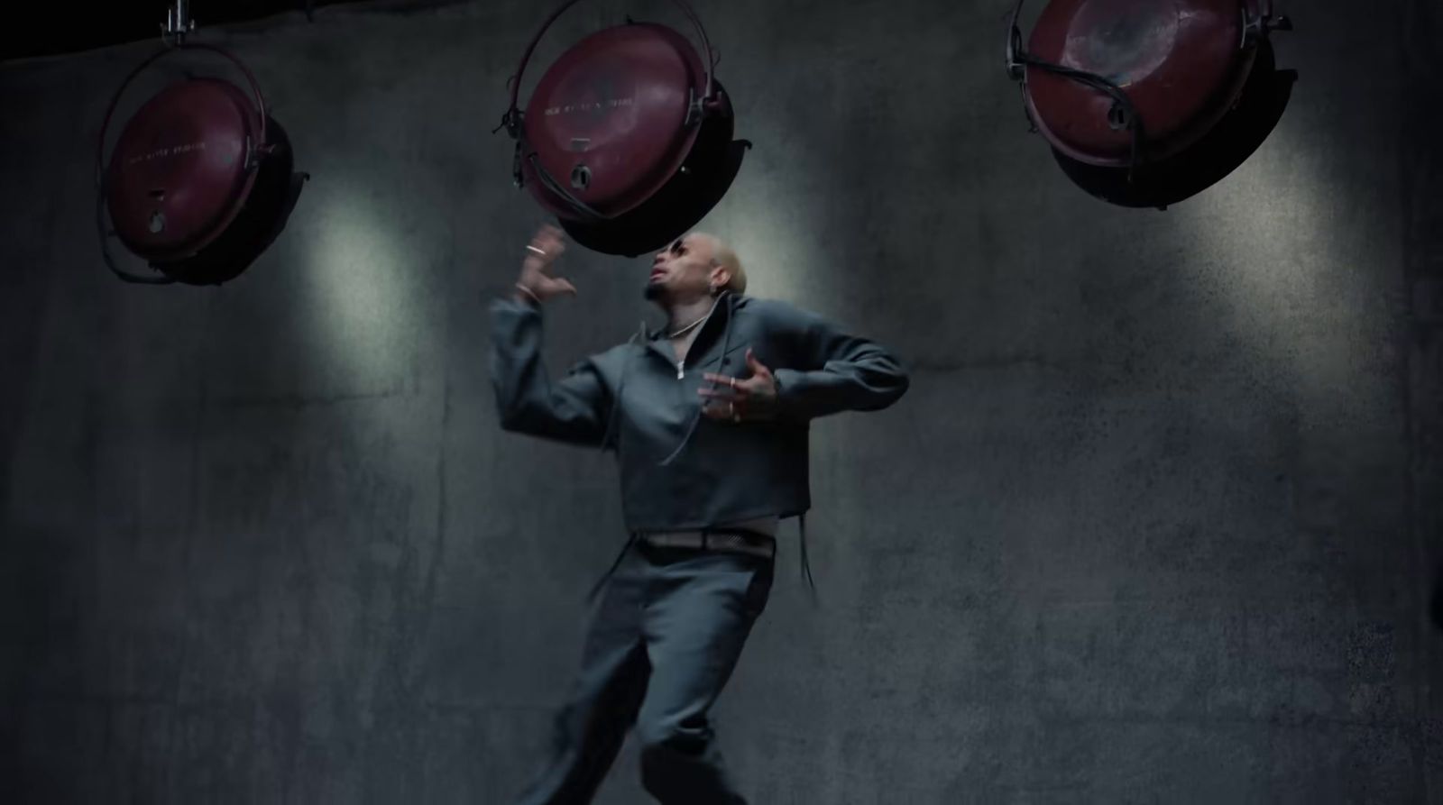 a man in a suit is juggling red balls