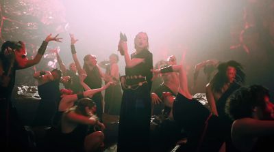 a group of women dancing in a dark room