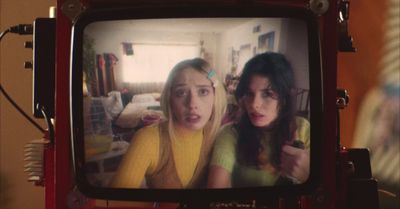 two young women are on a television screen