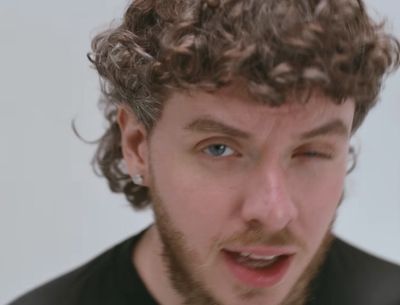 a close up of a person with curly hair