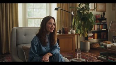 a woman sitting on a couch in a living room