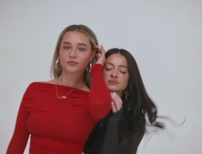 two women in red shirts are posing for a picture