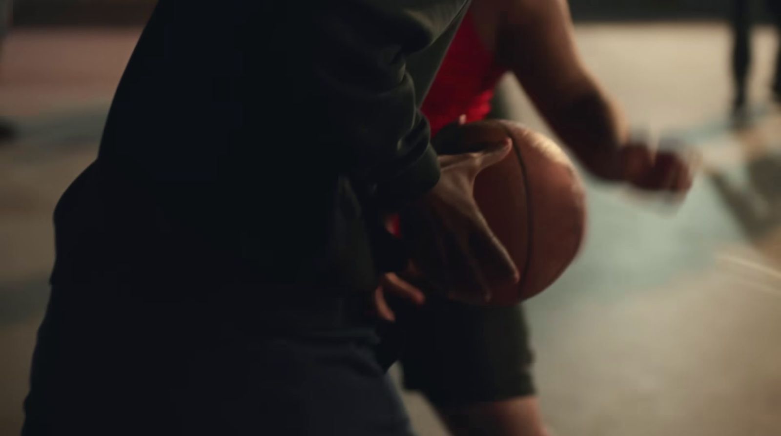 a man holding a basketball in his right hand