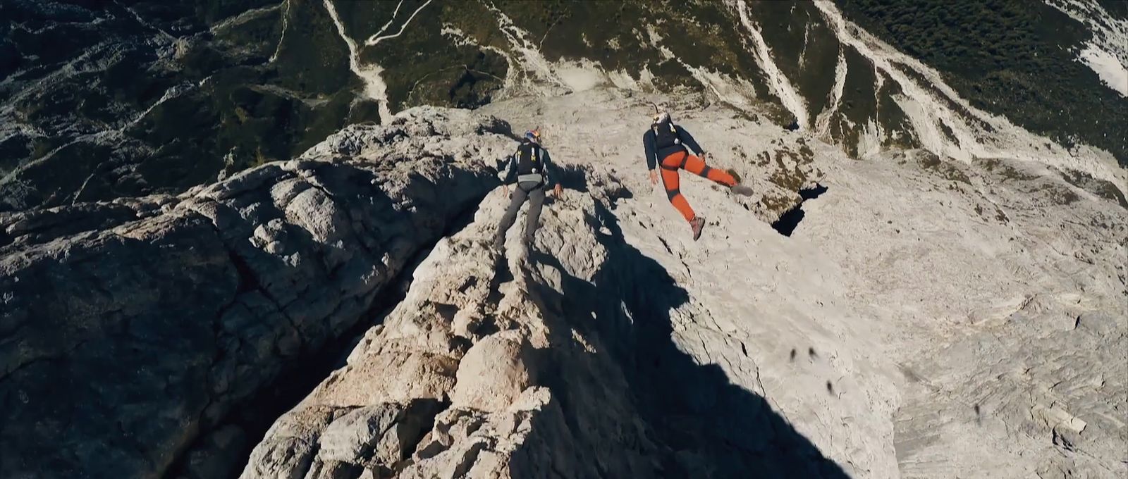 a man climbing up the side of a mountain