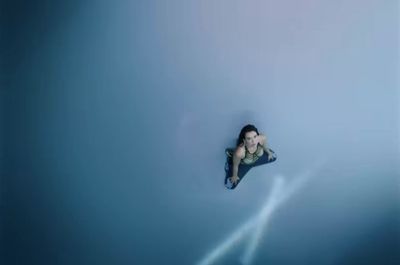 a woman floating in the water on a surfboard