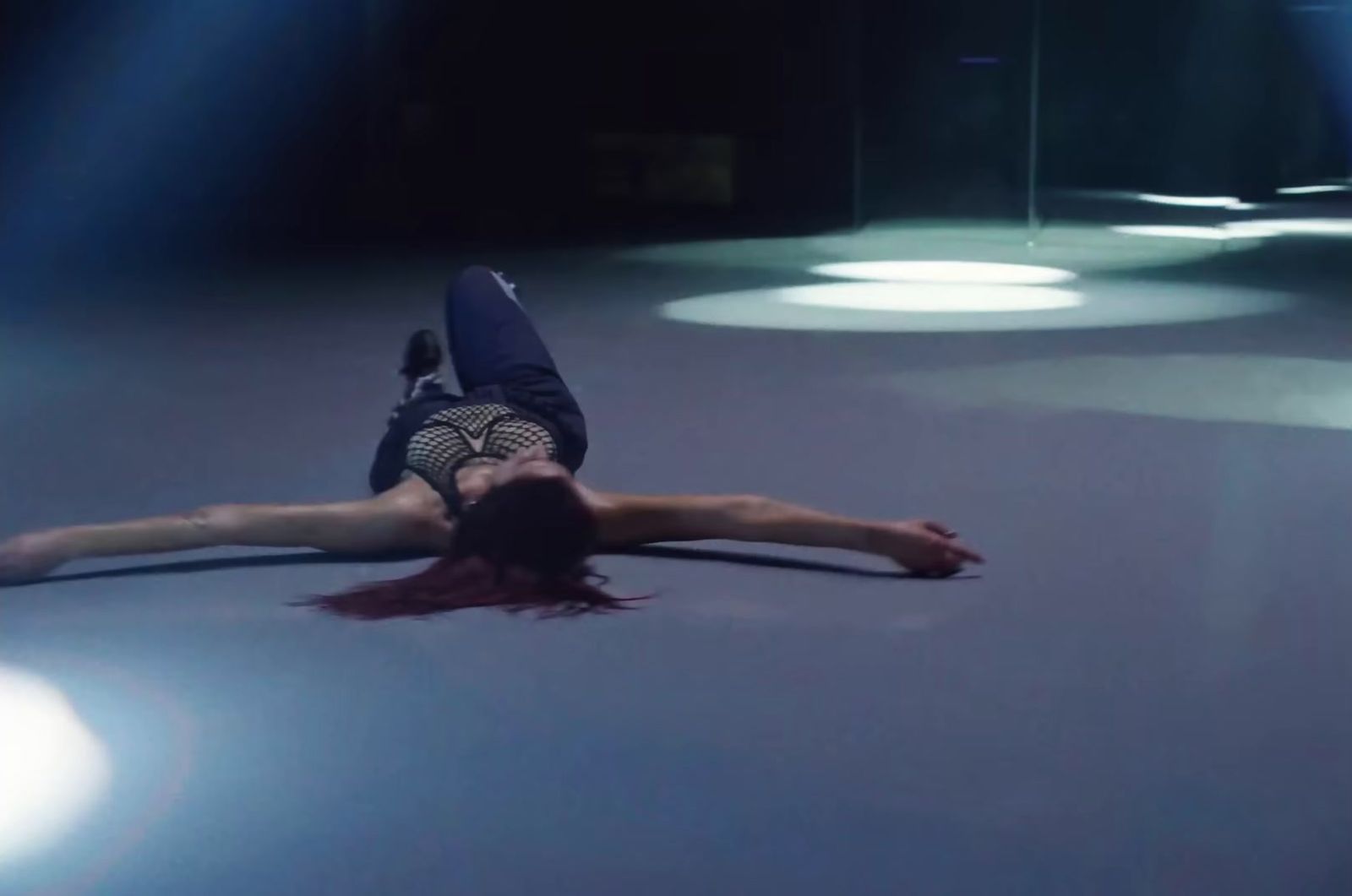 a person laying on the ground in a dark room