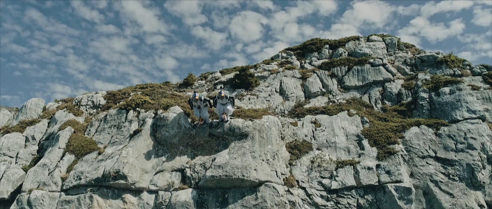 a group of people standing on top of a mountain