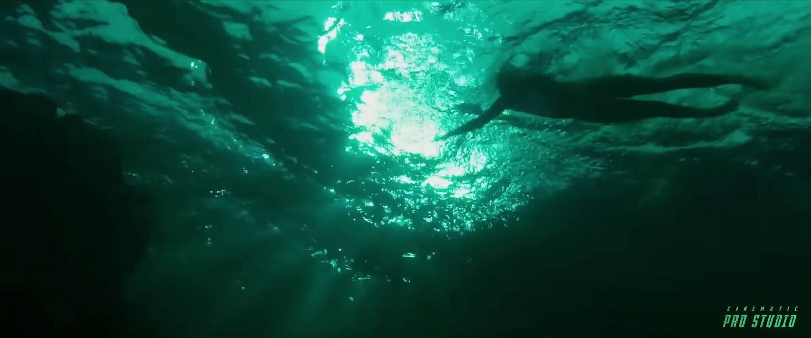 a large body of water with a person swimming in it