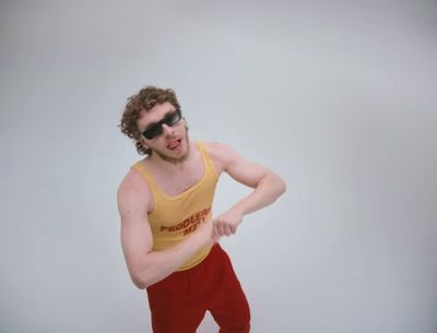 a man in a tank top and red pants