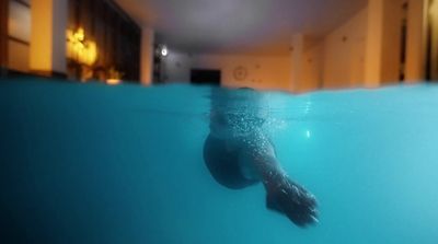 a person swimming in a pool of water