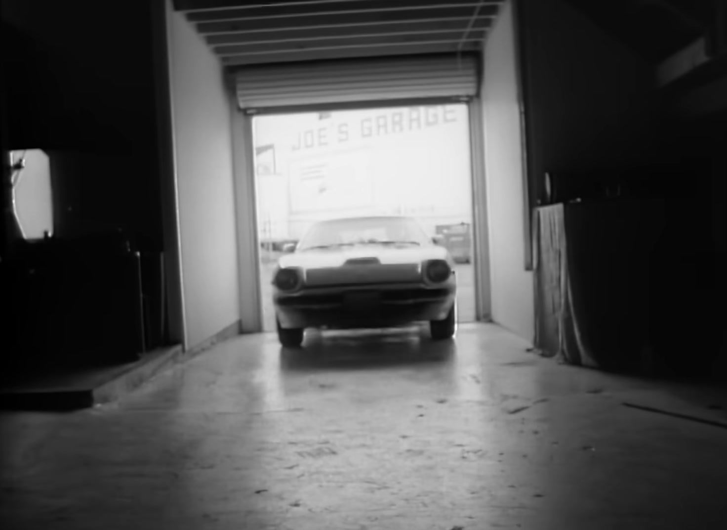 a white car is parked in a garage